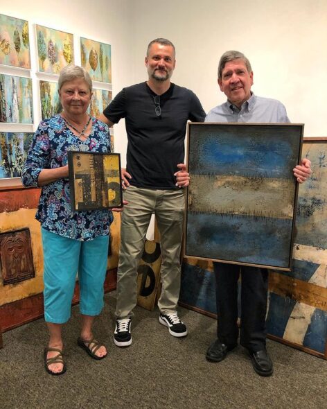 Artist Domenick Naccarato along with two art collectors and their newly acquired art.